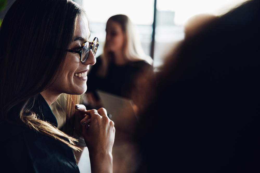 A smiling person in a meeting
